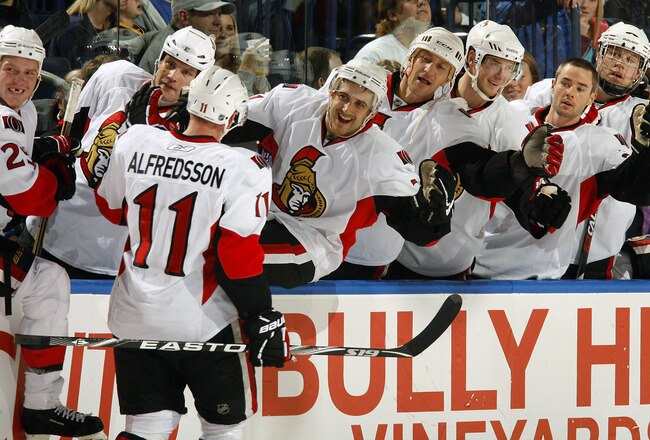 BUFFALO, NY - OCTOBER 22:  Daniel Alfredsson #11 of the Ottawa Senators celebrates his 1000th NHL point on a an empty net goal against the Buffalo Sabres  during their NHL game at HSBC Arena October 22, 2010 in Buffalo, New York.  (Photo By Dave Sandford/Getty Images)