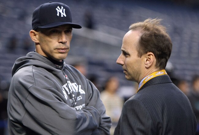 NEW YORK - OCTOBER 28:  Manager Joe Girardi (L) and General Manager Brian Cashman of the New York Yankees look on during batting practice against the Philadelphia Phillies in Game One of the 2009 MLB World Series at Yankee Stadium on October 28, 2009 in the Bronx borough of New York City.  (Photo by Al Bello/Getty Images)