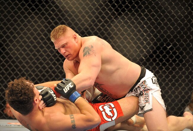 LAS VEGAS - JULY 11:  Brock Lesnar holds down Frank Mir during their heavyweight title bout during UFC 100 on July 11, 2009 in Las Vegas, Nevada. Lesnar defeated Mir by a second round knockout.  (Photo by Jon Kopaloff/Getty Images)