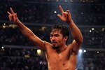 ARLINGTON, TX - MARCH 13:  Manny Pacquiao of the Philippines celebrates in the ring after defeating Joshua Clottey of Ghana during the WBO welterweight title fight at Cowboys Stadium on March 13, 2010 in Arlington, Texas. Pacquiao defeated Clottey by unanimous decision.  (Photo by Jed Jacobsohn/Getty Images)