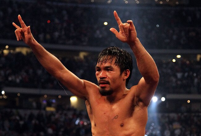 ARLINGTON, TX - MARCH 13:  Manny Pacquiao of the Philippines celebrates in the ring after defeating Joshua Clottey of Ghana during the WBO welterweight title fight at Cowboys Stadium on March 13, 2010 in Arlington, Texas. Pacquiao defeated Clottey by unanimous decision.  (Photo by Jed Jacobsohn/Getty Images)