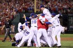 ARLINGTON, TX - OCTOBER 22:  Josh Hamilton #32 of the Texas Rangers dives on the pile as he celebrates with his teammates after the Rangers won 6-1 against the New York Yankees in Game Six of the ALCS during the 2010 MLB Playoffs at Rangers Ballpark in Arlington on October 22, 2010 in Arlington, Texas.  (Photo by Elsa/Getty Images)