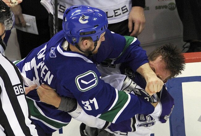 VANCOUVER, CANADA - APRIL 23:  Rick Rypien #37 of the Vancouver Canucks hits Richard Clune #56 of the Los Angeles Kings with a punch during a fight in the third period in Game Five of the Western Conference Quarterfinals during the 2010 NHL Stanley Cup Playoffs on April 23, 2010 at General Motors Place in Vancouver, British Columbia, Canada.  (Photo by Rich Lam/Getty Images)
