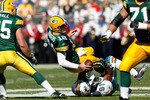 GREEN BAY, WI - OCTOBER 17: Aaron Rogers #12 of the Green Bay Packers is sacked by Cameron Wake #91 of the Miami Dolphins at Lambeau Field on October 17, 2010 in Green Bay, Wisconsin. (Photo by Scott Boehm/Getty Images)