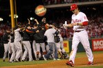 PHILADELPHIA - OCTOBER 23:  Chase Utley #26 of the Philadelphia Phillies walks off the field as the San Francisco Giants celebrate winning 3-2 to win the pennant in Game Six of the NLCS during the 2010 MLB Playoffs at Citizens Bank Park on October 23, 2010 in Philadelphia, Pennsylvania.  (Photo by Doug Pensinger/Getty Images)