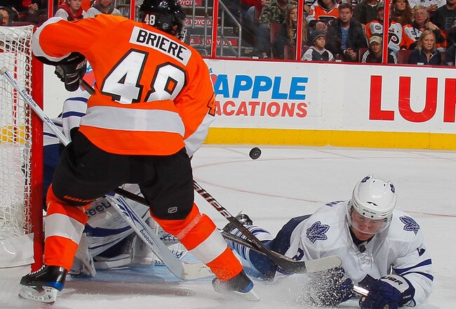 PHILADELPHIA - OCTOBER 23: Luke Schenn #2 of the Toronto Maple Leafs dives to the ice to help block a shot by Danny Briere #48 of the Philadelphia Flyers in the second period of a hockey game at the Wells Fargo Center on October 23, 2010 in Philadelphia, Pennsylvania.  (Photo by Paul Bereswill/Getty Images)