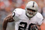 DENVER - OCTOBER 24:  Running back Darren McFadden #20 of the Oakland Raiders runs against the Denver Broncos at INVESCO Field at Mile High on October 24, 2010 in Denver, Colorado. (Photo by Justin Edmonds/Getty Images)