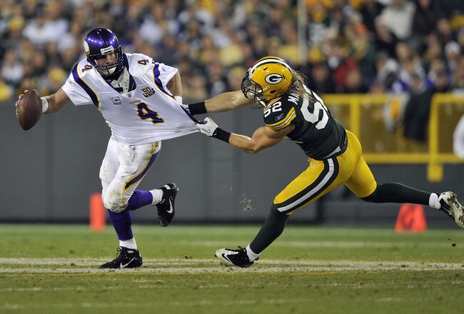 GREEN BAY, WI - OCTOBER 24:  Brett Favre #4 of the Minnesota Vikings has his jersey grabbed by Clay Matthews #52 of the Green Bay Packers at Lambeau Field on October 24, 2010 in Green Bay, Wisconsin. (Photo by Jim Prisching/Getty Images)