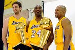 EL SEGUNDO, CA - SEPTEMBER 25:  Kobe Bryant #24  of the Los Angeles Lakers smiles as he holds two NBA Finals Larry O'Brien Championship Trophy's as he poses for a photograph with teammates Pau Gasol #16 and Derek Fisher #2 during Media Day at the Toyota Center on September 25, 2010 in El Segundo, California. NOTE TO USER: User expressly acknowledges and agrees that, by downloading and/or using this Photograph, user is consenting to the terms and conditions of the Getty Images License Agreement. (Photo by Kevork Djansezian/Getty Images)