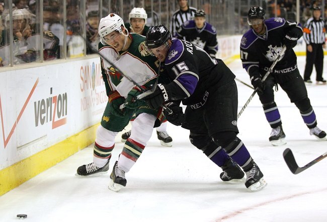 LOS ANGELES, CA - DECEMBER 28:  James Sheppard #51 of the Minnesota Wild and Brad Richardson #15 of the Los Angeles Kings vie for position to the puck during the NHL game at the Staples Center on December 28, 2009 in Los Angeles, California. The Wild defeated the Kings 4-3.  (Photo by Victor Decolongon/Getty Images)