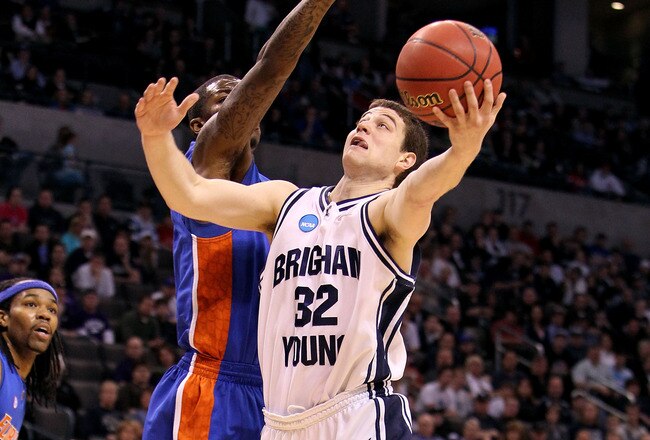 OKLAHOMA CITY - MARCH 18:  Jimmer Fredette #32 of the BYU Cougars drives for a shot attempt against Kenny Boynton #1 of the Florida Gators during the first round of the 2010 NCAA men�s basketball tournament at Ford Center on March 18, 2010 in Oklahoma City, Oklahoma.  (Photo by Ronald Martinez/Getty Images)