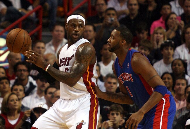 MIAMI - OCTOBER 05:  Forward LeBron James #6 of the Miami Heat takes on guard Tracy McGrady #1 of  the Detroit Pistons on October 5, 2010 in Miami, Florida.  NOTE TO USER: User expressly acknowledges and agrees that, by downloading and or using this photograph, User is consenting to the terms and conditions of the Getty Images License Agreement.  (Photo by Marc Serota/Getty Images)