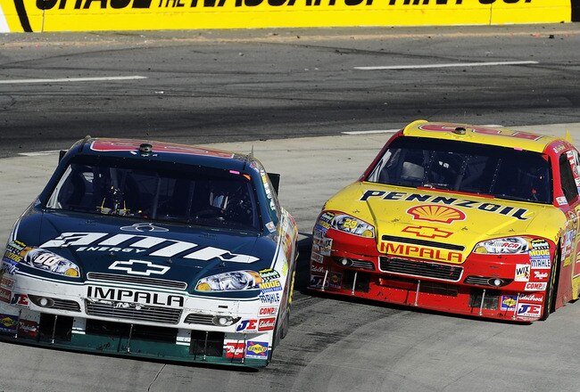 MARTINSVILLE, VA - OCTOBER 24:  Dale Earnhardt Jr., driver of the #88 AMP Energy/National Guard Chevrolet, leads Kevin Harvick, driver of the #29 Shell/Pennzoil Chevrolet,  during the NASCAR Sprint Cup Series TUMS Fast Relief 500 at Martinsville Speedway on October 24, 2010 in Martinsville, Virginia.  (Photo by John Harrelson/Getty Images)
