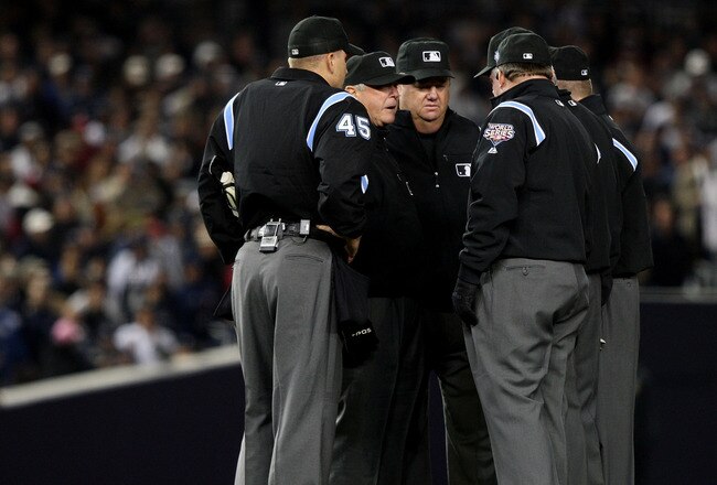 NEW YORK - OCTOBER 29:  The umpire crew talk on the field during Game Two of the 2009 MLB World Series at Yankee Stadium on October 29, 2009 in the Bronx borough of New York City.  (Photo by Jed Jacobsohn/Getty Images)
