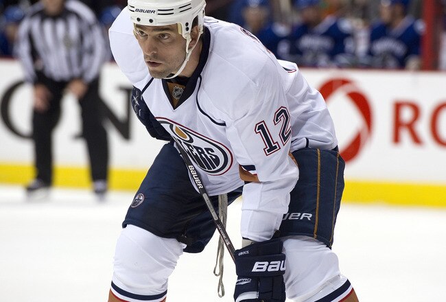 VANCOUVER, CANADA - SEPTEMBER 22: Alexandre Giroux #12 of the Edmonton Oilers gets ready for a face-off during NHL pre-season action against the Vancouver Canucks on September 22, 2010 at Rogers Arena in Vancouver, British Columbia, Canada.  (Photo by Rich Lam/Getty Images)