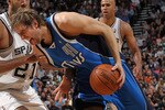 SAN ANTONIO - APRIL 25:  Forward Dirk Nowitzki #41 of the Dallas Mavericks dribbles the ball past Tim Duncan #21 of the San Antonio Spurs in Game Four of the Western Conference Quarterfinals during the 2010 NBA Playoffs at AT&T Center on April 25, 2010 in San Antonio, Texas. NOTE TO USER: User expressly acknowledges and agrees that, by downloading and or using this photograph, User is consenting to the terms and conditions of the Getty Images License Agreement.  (Photo by Ronald Martinez/Getty Images)