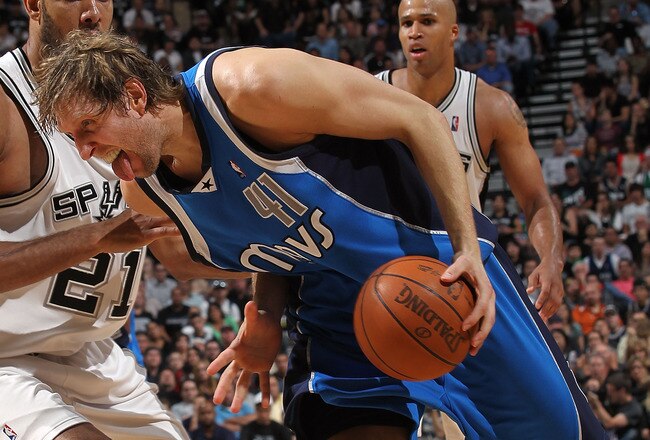 SAN ANTONIO - APRIL 25:  Forward Dirk Nowitzki #41 of the Dallas Mavericks dribbles the ball past Tim Duncan #21 of the San Antonio Spurs in Game Four of the Western Conference Quarterfinals during the 2010 NBA Playoffs at AT&T Center on April 25, 2010 in San Antonio, Texas. NOTE TO USER: User expressly acknowledges and agrees that, by downloading and or using this photograph, User is consenting to the terms and conditions of the Getty Images License Agreement.  (Photo by Ronald Martinez/Getty Images)