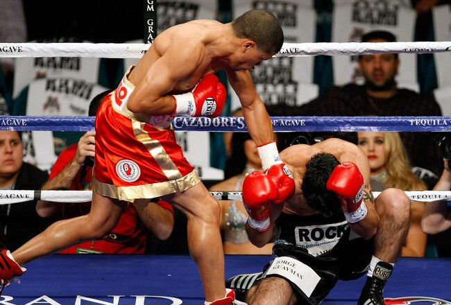 LAS VEGAS - DECEMBER 06:  (L-R) Juan Manuel Lopez of Puerto Rico connects a left to the head of Sergio Medina of Argentina during their WBO junior featherweight title fight at the MGM Grand Garden Arena December 6, 2008 in Las Vegas, Nevada.  (Photo by Ethan Miller/Getty Images)