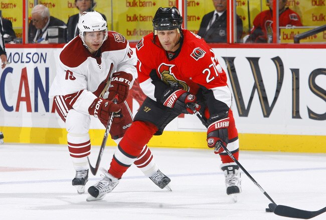 OTTAWA, ON - OCTOBER 26:  Alex Kovalev #27 of the Ottawa Senators carries the puck hard to the net while being pursued by Ray Whitney #13 of the Phoenix Coyotes during a game at Scotiabank Place on October 26, 2010 in Ottawa, Ontario, Canada.  The Ottawa Senators defeated the Phoenix Coyotes 5-2.  (Photo by Phillip MacCallum/Getty Images)