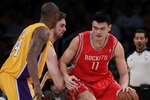 LOS ANGELES, CA - OCTOBER 26:  Pau Gasol #16 of the Los Angeles Lakers defends as Yao Ming #11 of the Houston Rockets controls the ball during their NBA game at Staples Center on October 26, 2010 in Los Angeles, California. NOTE TO USER: User expressly acknowledges and agrees that, by downloading and or using this photograph, User is consenting to the terms and conditions of the Getty Images License Agreement.  (Photo by Jeff Gross/Getty Images)