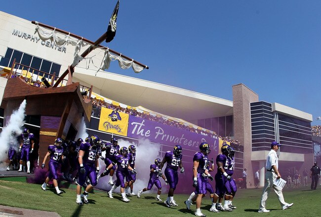GREENVILLE, NC - SEPTEMBER 05:  Head coach Skip Holtz of the East Carolina Pirates walks onto the field with his team before their game against the Appalachian State Mountaineers at Dowdy-Ficklen Stadium on September 5, 2009 in Greenville, North Carolina.  (Photo by Streeter Lecka/Getty Images)