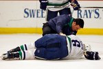 CHICAGO - MAY 09: A trainer attends to Sami Salo #6 of the Vancouver Canucks at the end of the first period after Salo suffered an injury against the Chicago Blackhawks in Game Five of the Western Conference Semifinals during the 2010 NHL Stanley Cup Playoffs at United Center on May 9, 2010 in Chicago, Illinois. The Canucks defeated the Blackhawks 4-1. (Photo by Jonathan Daniel/Getty Images)