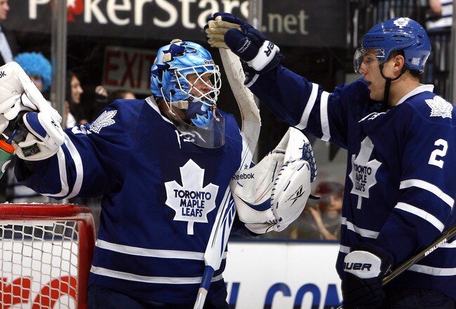 TORONTO - OCTOBER 26: Jean-Sebastien Giguere #35 and Luke Schenn #2 of the Toronto Maple Leafs celebrate win against the Florida Panthers during game action at the Air Canada Centre October 26, 2010 in Toronto, Ontario, Canada. The Leafs won 3-1. (Photo by Abelimages/Getty Images)