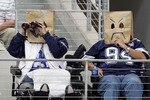 ARLINGTON, TX - OCTOBER 31:  Fans of the Dallas Cowboys wear brown paper bags over their head as they watch the Cowboys play against the Jacksonville Jaguars at Cowboys Stadium on October 31, 2010 in Arlington, Texas.  (Photo by Chris Chambers/Getty Images)