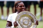 LONDON, ENGLAND - JULY 03:  Serena Williams of USA lifts the Championship trophy after winning her Ladies Singles Final Match against Vera Zvonareva of Russia on Day Twelve of the Wimbledon Lawn Tennis Championships at the All England Lawn Tennis and Croquet Club on July 3, 2010 in London, England.  (Photo by Julian Finney/Getty Images)