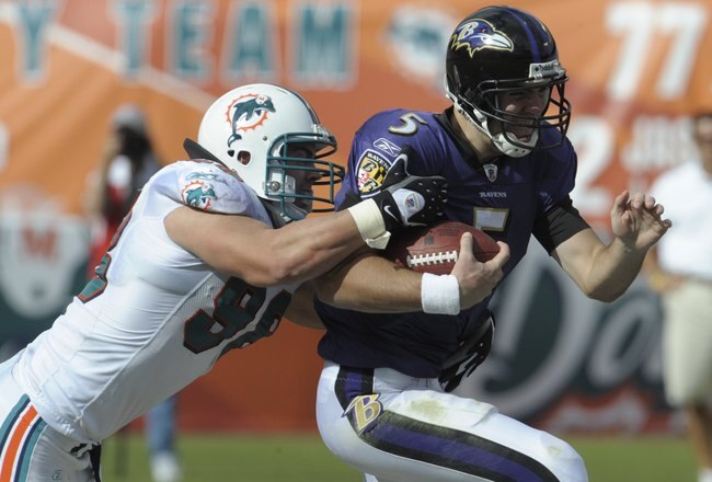 MIAMI, FL - JANUARY 4:  Linebacker Matt Roth #98 of the Miami Dolphins tackles quarterback Joe Flacco #5 of the Baltimore Ravens  in an NFL Wildcard Playoff Game at Dolphins Stadium on January 4, 2009 in Miami, Florida.  (Photo by Al Messerschmidt/Getty Images)