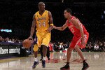 LOS ANGELES, CA - OCTOBER 26:  Kobe Bryant #24 of the Los Angeles Lakers drives with the ball against Kevin Martin #12 of the Houston Rockets during their opening night game at Staples Center on October 26, 2010 in Los Angeles, California. NOTE TO USER: User expressly acknowledges and agrees that, by downloading and or using this photograph, User is consenting to the terms and conditions of the Getty Images License Agreement.  (Photo by Jeff Gross/Getty Images)