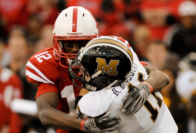 LINCOLN, NE - OCTOBER 30: Safety Courtney Osborne #12 of the Nebraska Cornhuskers hits  quarterback Blaine Gabbert #11 of the Missouri Tigers during second half action of their game at Memorial Stadium on October 30, 2010 in Lincoln, Nebraska. Nebraska Defeated Missouri 31-17. (Photo by Eric Francis/Getty Images)