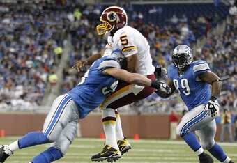 DETROIT - OCTOBER 31: Kyle Vanden Bosch #93 of the Detroit Lions hits Donovan McNabb #5 of the Washington Redskins during the first quarter of the game at Ford Field on October 31, 2010 in Detroit, Michigan. (Photo by Leon Halip/Getty Images)