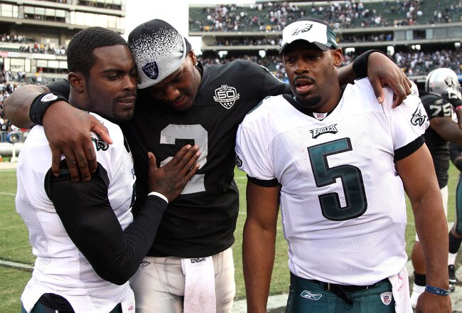 OAKLAND, CA - OCTOBER 18:  Donovan McNabb #5 of the Philadelphia Eagles talks with teammate Michael Vick #7 and JaMarcus Russell #2 of the Oakland Raiders at the end of an NFL game at the Oakland-Alameda County Coliseum on October 18, 2009 in Oakland, California.  (Photo by Jed Jacobsohn/Getty Images)