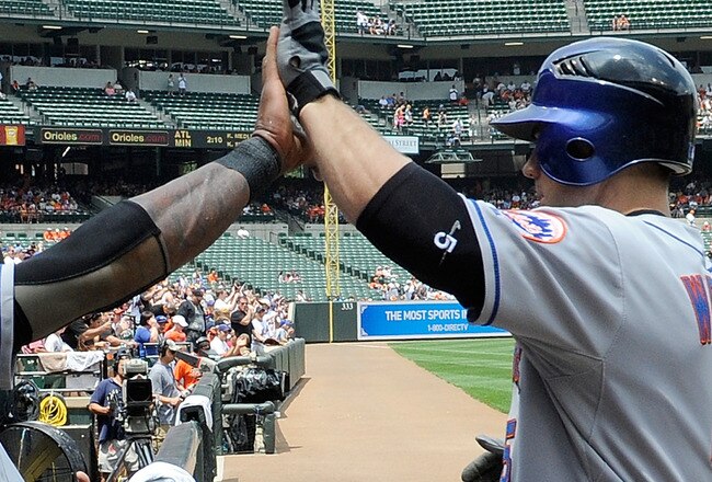 BALTIMORE - JUNE 13:  David Wright #5 of the New York Mets is congratulated by Jose Reyes #7 after hitting a home run in the first inning against the Baltimore Orioles at Camden Yards on June 13, 2010 in Baltimore, Maryland.  (Photo by Greg Fiume/Getty Images)
