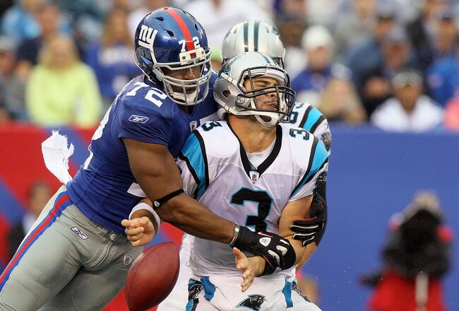 EAST RUTHERFORD, NJ - SEPTEMBER 12:  Osi Umenyiora #72 of the New York Giants forces a fumble against Matt Moore #3 of the Carolina Panthers during the fourth quarter on September 12, 2010 at the New Meadowlands Stadium in East Rutherford, New Jersey. The Giants defeated the Panthers 31-18. Moore was injured on the play and left the game. (Photo by Jim McIsaac/Getty Images)
