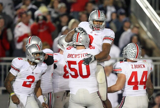 STATE COLLEGE, PA - NOVEMBER 7: Running back Brandon Saine #3 of the Ohio State Buckeyes celebrates his touchdown with offensive lineman Michael Brewster #50 during a game against the Penn State Nittany Lions on November 7, 2009 at Beaver Stadium in State College, Pennsylvania. Ohio State won 24-7. (Photo by Hunter Martin/Getty Images)