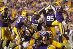 BATON ROUGE, LA - OCTOBER 16:  Drake Nevis #92  of the Louisiana State University Tigers tackles for a safety in the endzone Andre Anderson #22 of the McNeese State Cowboys at Tiger Stadium on October 16, 2010 in Baton Rouge, Louisiana.  (Photo by Chris Graythen/Getty Images)