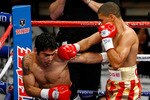 LAS VEGAS - DECEMBER 06:  (R-L) Juan Manuel Lopez of Puerto Rico connects a right to the head of Sergio Medina of Argentina during their WBO junior featherweight title fight at the MGM Grand Garden Arena December 6, 2008 in Las Vegas, Nevada.  (Photo by Ethan Miller/Getty Images)