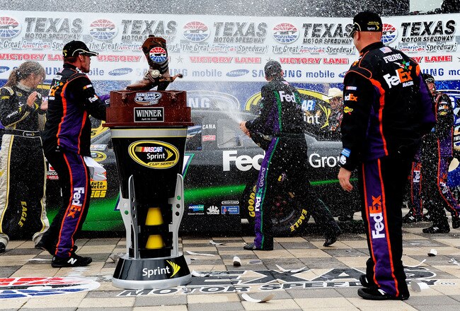FORT WORTH, TX - APRIL 19:  Denny Hamlin, driver of the #11 of the FedEx Ground Toyota, celebrates with crew members in victory lane after he won the NASCAR Sprint Cup Series Samsung Mobile 500 at Texas Motor Speedway on April 19, 2010 in Fort Worth, Texas.  (Photo by John Harrelson/Getty Images for NASCAR)