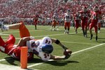 SALT LAKE CITY - SEPTEMBER 30:   Brad Lau #34 of the Boise State Broncos is tackled by Joe Jiannoni #44 of the Utah Utes but stretches over the goal line with the ball to score a touchdown at Rice-Eccles Stadium on September 30, 2006 in Salt Lake City, Utah.  (Photo by Kent Horner/Getty Images)