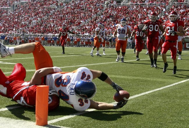 SALT LAKE CITY - SEPTEMBER 30:   Brad Lau #34 of the Boise State Broncos is tackled by Joe Jiannoni #44 of the Utah Utes but stretches over the goal line with the ball to score a touchdown at Rice-Eccles Stadium on September 30, 2006 in Salt Lake City, Utah.  (Photo by Kent Horner/Getty Images)