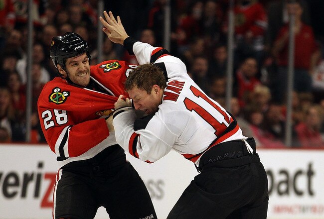CHICAGO - NOVEMBER 03: Jack Dowell #28 of the Chicago Blackhawks fights with Adam Mair #10 of the New Jersey Devils at the United Center on November 3, 2010 in Chicago, Illinois. (Photo by Jonathan Daniel/Getty Images)