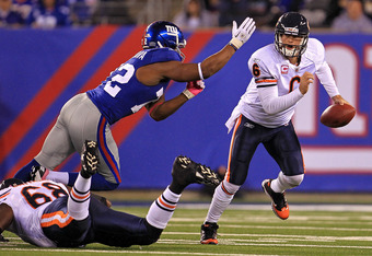 EAST RUTHERFORD, NJ - OCTOBER 03:  Jay Cutler #6 of the Chicago Bears gets chased by Osi Umenyiora #72 of the New York Giants at New Meadowlands Stadium on October 3, 2010 in East Rutherford, New Jersey.  (Photo by Chris McGrath/Getty Images)