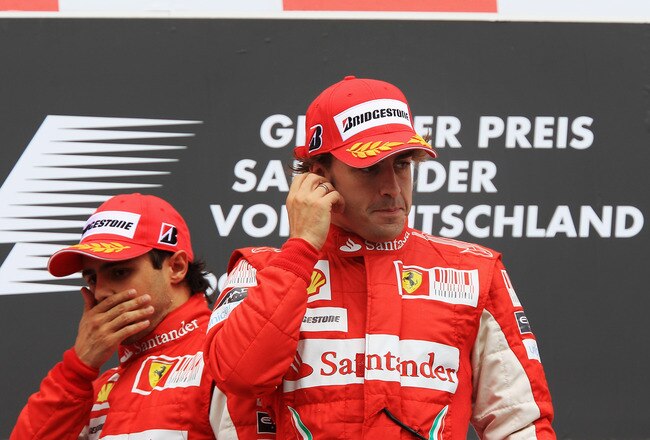 HOCKENHEIM, GERMANY - JULY 25:  Race winner Fernando Alonso (R) of Spain and Ferrari celebrates on the podium with second placed Felipe Massa (L) of Brazil and Ferrari following the German Grand Prix at Hockenheimring on July 25, 2010 in Hockenheim, Germany.  (Photo by Mark Thompson/Getty Images)
