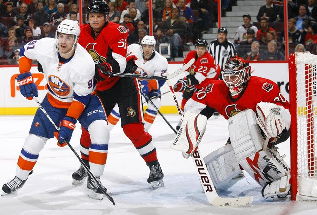 OTTAWA, ON - NOVEMBER 04:  Brian Elliott #30 of the Ottawa Senators watches the play along the boards while teammate Sergei Gonchar #55 keeps a close check on John Tavares #91 of the New York Islanders during a game on November 4, 2010 at Scotiabank Place in Ottawa, Ontario, Canada.  The Ottawa Senators defeated the New York Islanders 4-1. (Photo by Phillip MacCallum/Getty Images)