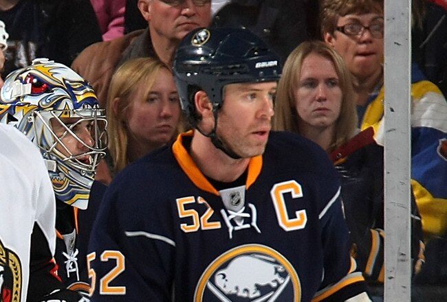 BUFFALO - OCTOBER 22:  Craig Rivet #52 of the Buffalo Sabres keeps an eye on the play along with teammate Ryan Miller #30 and Chris Neil #25 of the Ottawa Senators during their NHL game at HSBC Arena October 22, 2010 in Buffalo, New York.(Photo By Dave Sandford/Getty Images)