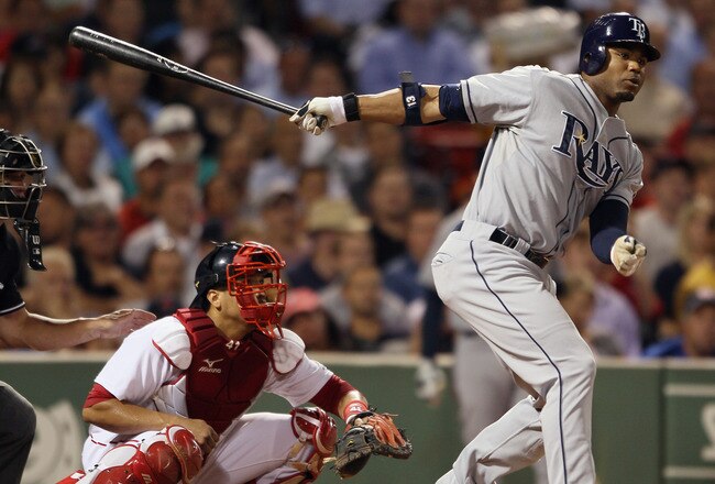 BOSTON - SEPTEMBER 07:  Carl Crawford #13 of the Tampa Bay Rays hits a 2 RBI double in the fourth inning as Victor Martinez #41 of the Boston Red Sox catches on September 7, 2010 at Fenway Park in Boston, Massachusetts.  (Photo by Elsa/Getty Images)