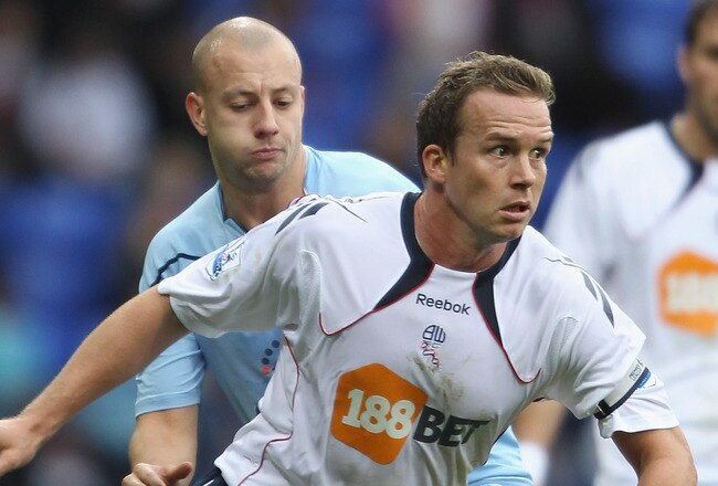BOLTON, ENGLAND - NOVEMBER 06:  Kevin Davies of Bolton Wanderers holds off a challenge from Alan Hutton of Tottenham Hotspur during the Barclays Premier League match between Bolton Wanderers and Tottenham Hotspur at the Reebok Stadium on November 6, 2010 in Bolton, England.  (Photo by Clive Brunskill/Getty Images)