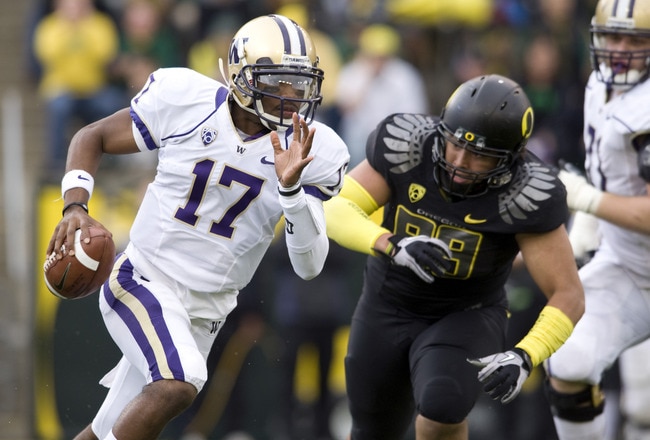 EUGENE, OR - NOVEMBER 6: Quarterback Keith Price #17 of the Washington Huskies is chased by defensive tackle Zac Clark #99 of the Oregon Ducks in the third quarter of the game at Autzen Stadium on November 6, 2010 in Eugene, Oregon. The Ducks won the game 53-16. (Photo by Steve Dykes/Getty Images)
